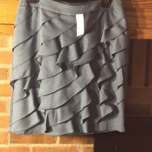 Skirt with front diagonal ruffles. Plain zippered back. Size 6